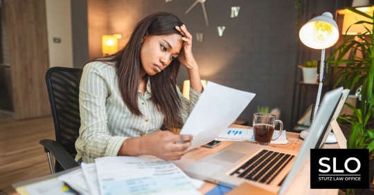 Worried young black women stressing over her financial bills